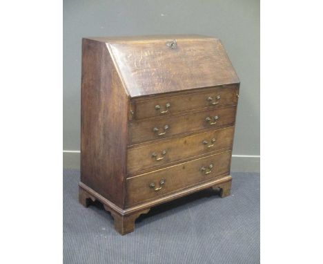A George III oak bureau, the fall front enclosing a fitted interior over four long graduating drawers on bracket feet 107 x 9