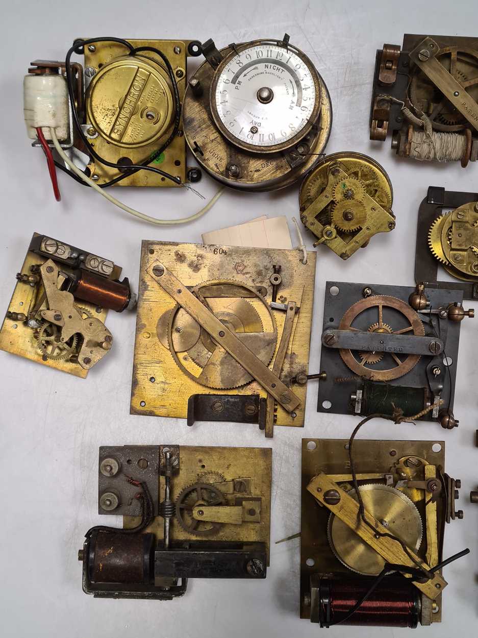 A quantity of various electric clock movements, including Synchronome