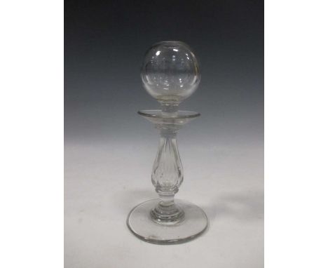 A 19th century glass lace maker's lamp, the bulbous body on a baluster stem and spreading circular base, 22.5cm high