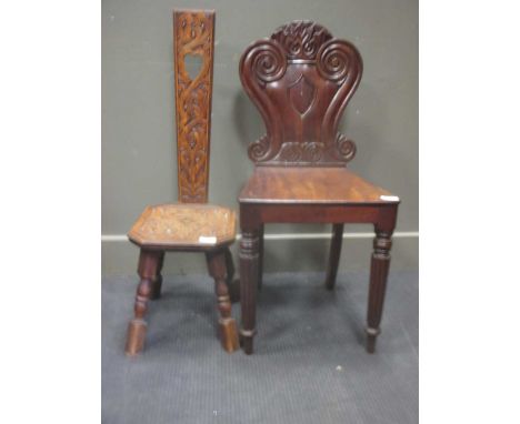 A 19th century mahogany hall chair together with a carved oak high backed stool (2)