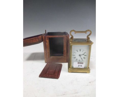A brass carriage clock with original travelling case and key