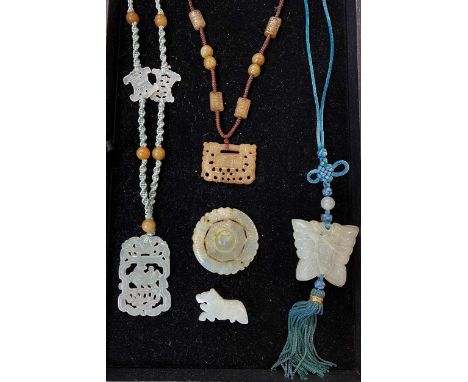 A collection of Chinese jade/ Jadeite necklaces together with an ornament and a spinner