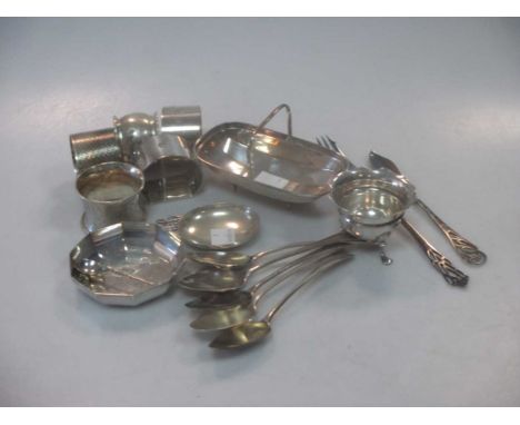 A collection of silver wares including napkin rings, flatware, a miniature trug and a continental metalwares caddy spoon, 12.