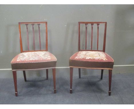 A pair of Georgian, possibly fruitwood, stick back dining chairs with square tapered legs on spade feet and tapestry seats (2