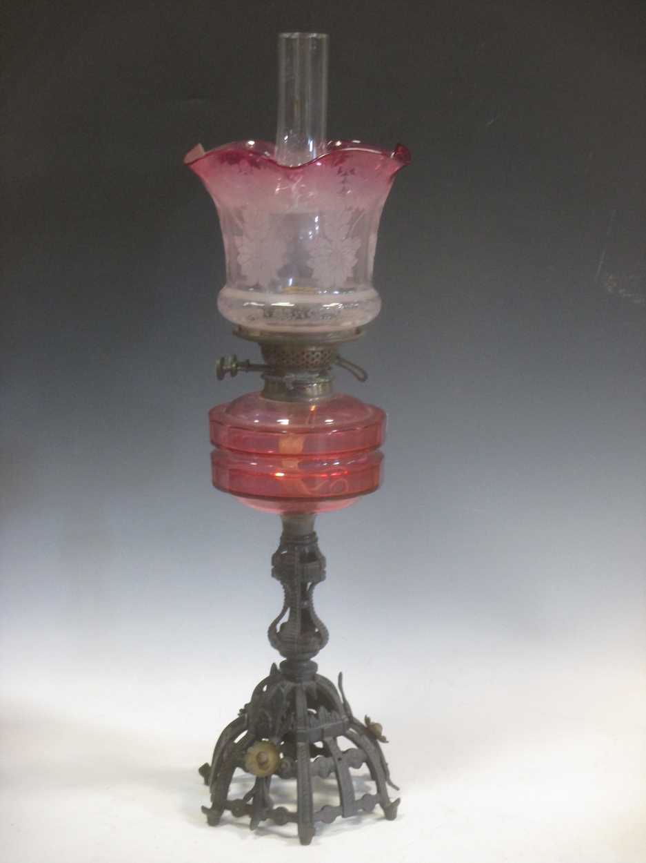 A Victorian cranberry glass etched oil lamp, total height 70cm in