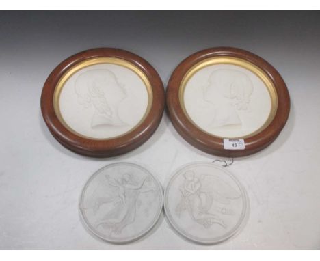 Two framed plaster portrait roundels together with a pair of parian cherubic roundels (4)