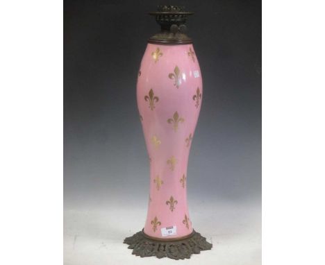 A late 19th century porcelain and brass mounted oil lamp with repeating fleur de lys decoration 63.5cm high