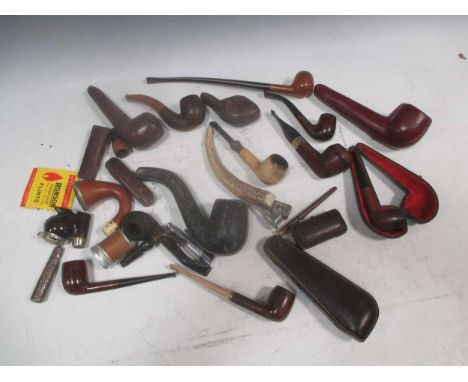 A collection of vintage pipes and smoking accessories, including two Dunhill lighters, another by Dupont, a Dunhill triple pi