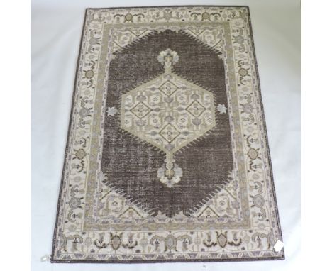 An Agra style woollen carpet, on a cream ground, 231 x 161cm