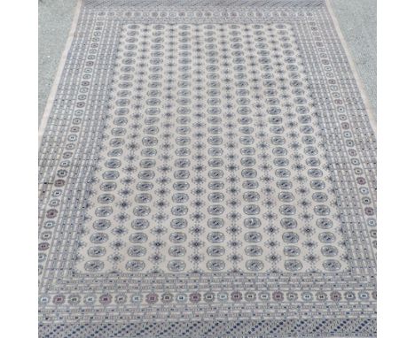 A Bokhara carpet, with all over medallions, on a cream ground, 362 x 289cm