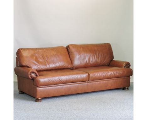 A John Lewis brown leather upholstered three seater sofa, 220cm