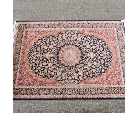 A Keshan carpet, with a central medallion and floral design, on a blue field, 230 x 160cm