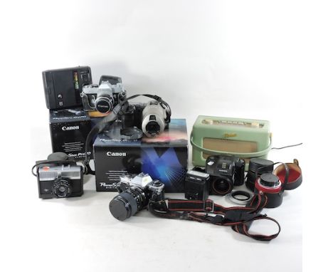 A Canon PowerShot Pro70 digital camera, together with another, a collection of other cameras and a green Robertson radio