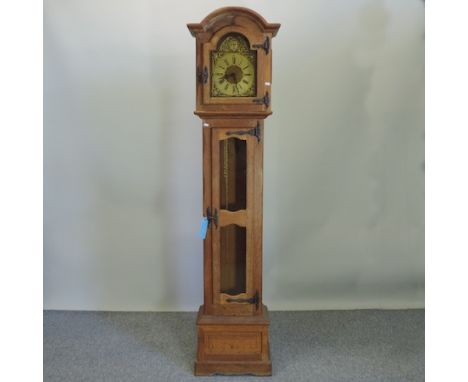 An oak cased longcase clock, having a three train movement, with Westminster chimes, with three brass cased weights, 211cm ta