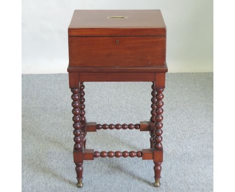 A 19th century mahogany ladies work box, on a bobbin turned stand, 43cm