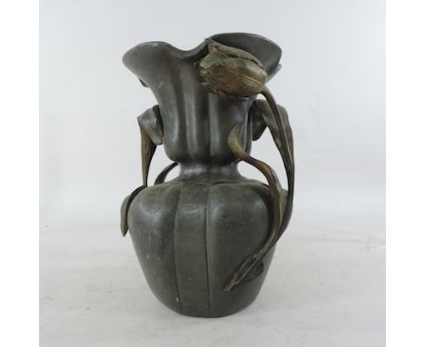 An early 20th century art nouveau style lead vase, relief decorated with flowers, 25cm tall