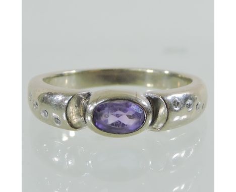 An 18 carat white gold, amethyst and diamond ring, boxed 