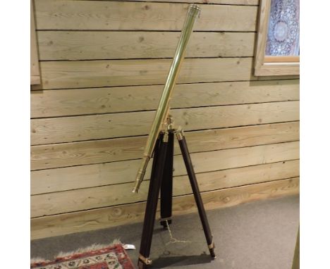 A brass telescope, on tripod stand, 140cm tall approx