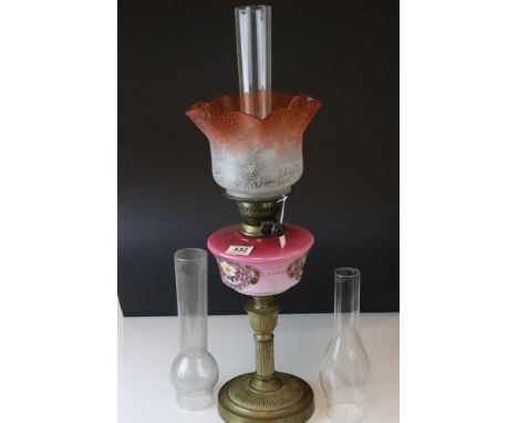 A 19th century oil lamp with cranberry etched glass shade, hand painted opaline glass reservoir with three glass funnels. 