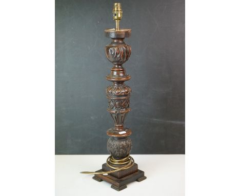A vintage carved wooden table lamp together with a decorative brass sword. 