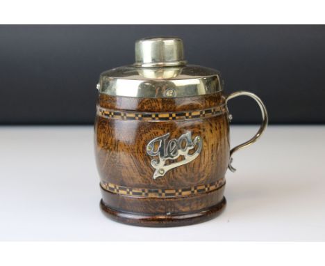 A 20th century oak and plated tea caddy in the form of a cup or tankard. 