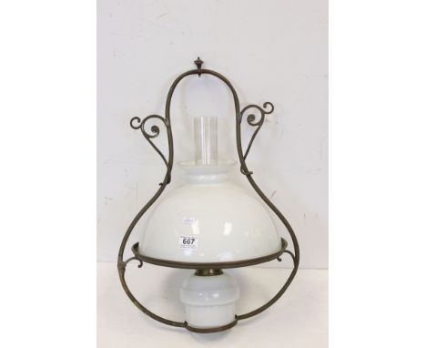 A antique brass hanging oil lamp with with white glass shade and well 