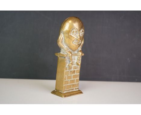A vintage brass money box in the form of Humpty Dumpty. 