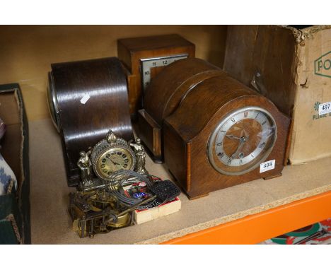 A collection of four vintage wooden cased mantle clocks. 