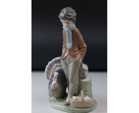 A Lladro figure of a young boy with a turkey out egg collecting, measures approx 26cm in height.