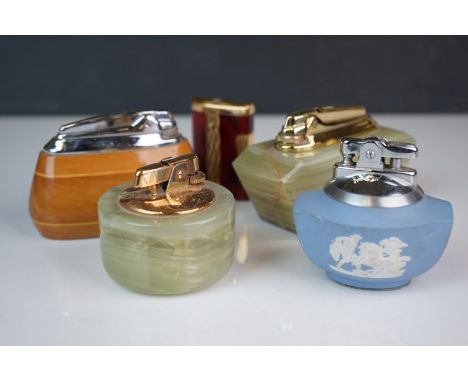 A collection of five vintage Ronson lighters to include four table lighters and a pocket lighter. 