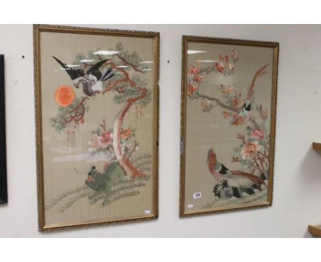 A pair of framed and glazed Oriental woolwork tapestry pictures of exotic birds. 