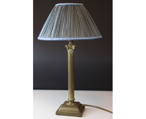 A contemporary brass table lamp of Corinthian column form with shade.