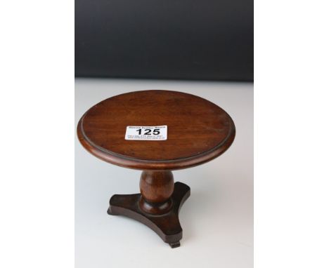 A 19th century mahogany miniature or Apprentice type tripod table with a turned vase column with paper label to underside rea