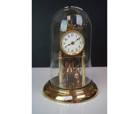 A vintage brass anniversary clock with glass dome. 