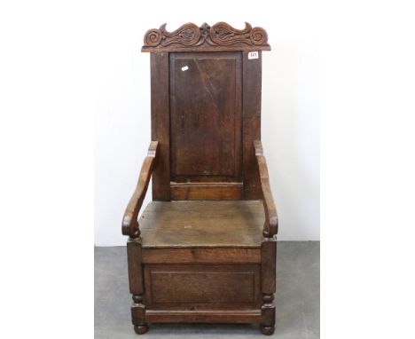 Late 17th century Oak Commode Chair, the carved top rail over a panelled back and solid seat (adapted), 51cms wide x 103cms h