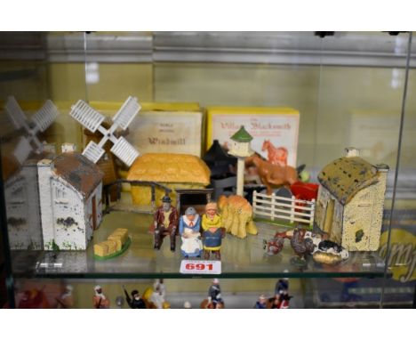 A collection of vintage metal farm models,&nbsp;to include cottages, haystack, animals, people, dovecot, etc, with examples b