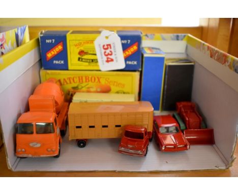 Five Matchbox vehicles,&nbsp;comprising: Pontiac Coupe, No.22; Drott Excavator, No.58; Major Pack Cattle Truck, No.7; and a K