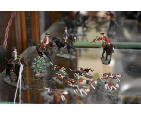 A group of small scale vintage metal figures,&nbsp;comprising: hunt master; three further mounted riders; and pack of hounds.