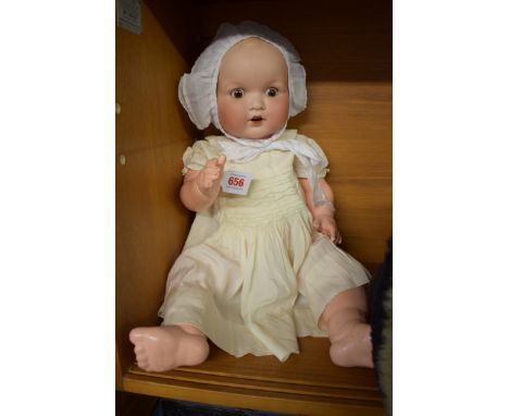 Doll:&nbsp;an old Armand Marseille baby doll, impressed mark 'A.M. Germany 5/8./9.K.', approx. 58cm long. 