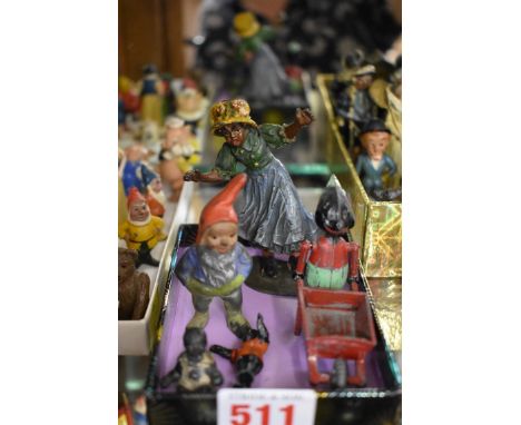 Heyde:&nbsp;a vintage painted lead girl on roller skates; together with another articulated figure pushing wheelbarrow; a gno