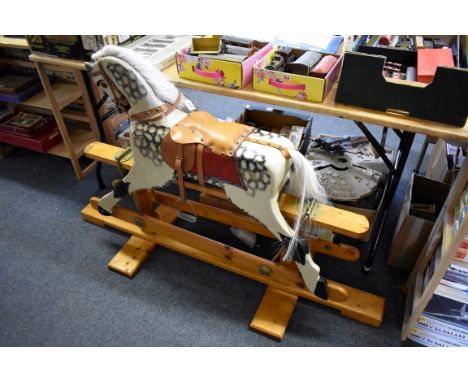 Rocking Horse:&nbsp;a vintage painted grey dappled rocking horse, with tan leather saddle and reins on pine base, floor to to