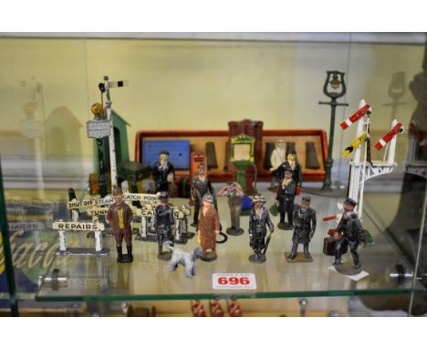 A collection of vintage metal railway platform items, with examples by Britains, Johillco and others, to include: passengers,