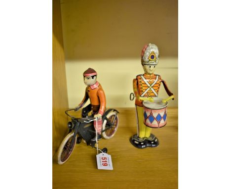 A vintage clockwork tinplate drummer,&nbsp;by Marx; together with another similar unidentified cyclist. 