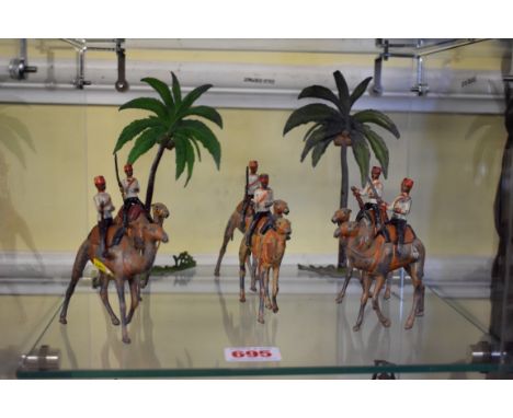 Britains:&nbsp;a&nbsp;vintage Egyptian Camel Corps group of six; together with two palm trees, (paint loss to all figures and