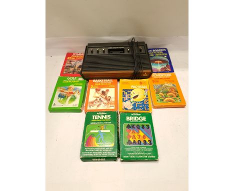 Atari, a unboxed CX2600 Computer Video Game Console with a Collection of boxed Games. Includes Adventure, Space Invaders with