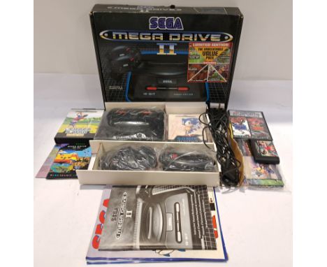 Sega, a boxed "Mega Drive II" Video Game Console with a Group of Games. Includes Sonic the Hedgehog, EA Sports Double Header 