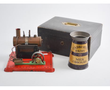 A tray of collectables, a Mamod steam engine, old glass bottles, a trivet, a tin plate Cadbury's Milk Chocolate can, two bott