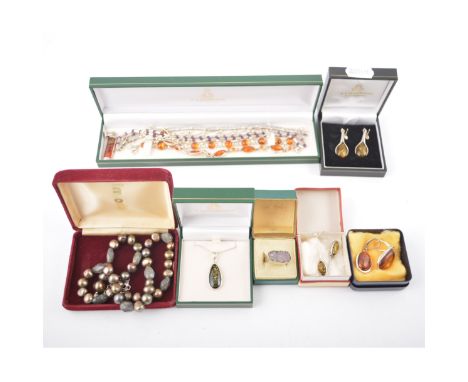 A collection of modern baltic amber jewellery, three pairs of earrings, two pendants and two bracelets, an amethyst crystal r