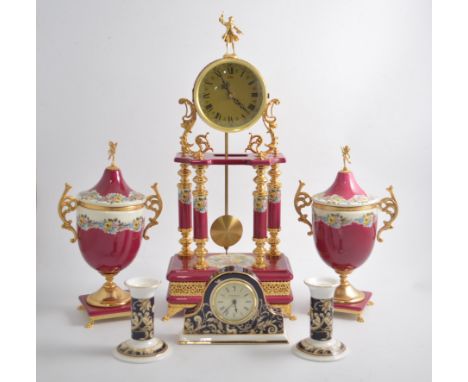 A large modern ceramic clock garniture in the traditional style, cerise and gilt with floral panels, 50cm,a Wedgwood mantel c