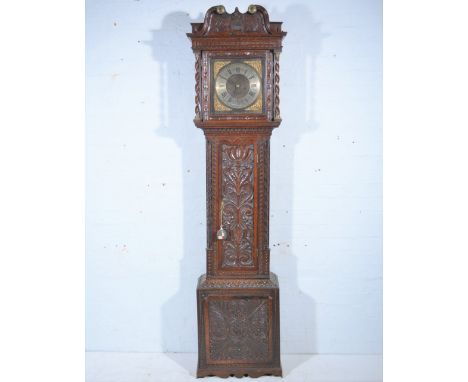 Oak longcase clock, heavily carved case, swan-neck pediment, the hood with barleytwist supports, long arched door flanked by 